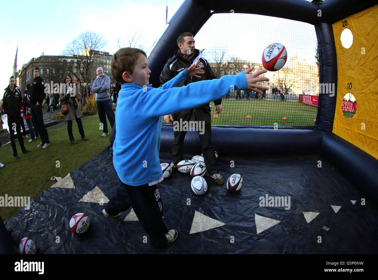 Edinburgh Rugby's Greig Laidlaw watches seven year old William Hodgson