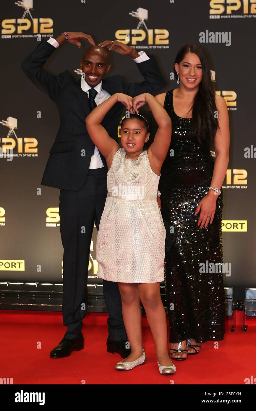 Mo Farah does the Mobot with his daughter Rihanna alongside his wife Tania  as they arrive for the Sports Personality of the Year Awards 2012, at the  ExCel Arena, London Stock Photo -