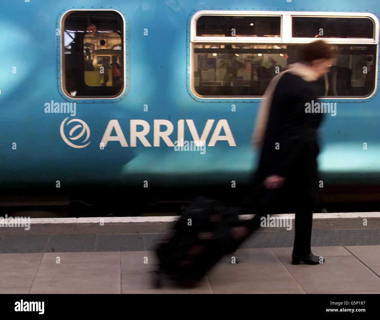 Please be aware that this picture shows a train operated by Arriva Trains Northern, and that from 1 Feb 2004 this franchise is run by Northern Rail. Accordingly, this picture should not be used to illustrate any story relating to Arriva franchises. A passenger walks passed an Arriva train on a platform at Manchester's Piccadilly station. The advertising watchdog told a train company not to repeat 'misleading claims that it was offering passengers an 'efficient service'. * ... In a recruitment advert, Arriva Trains Northern said it 'provided efficient passenger rail services across the North Stock Photo