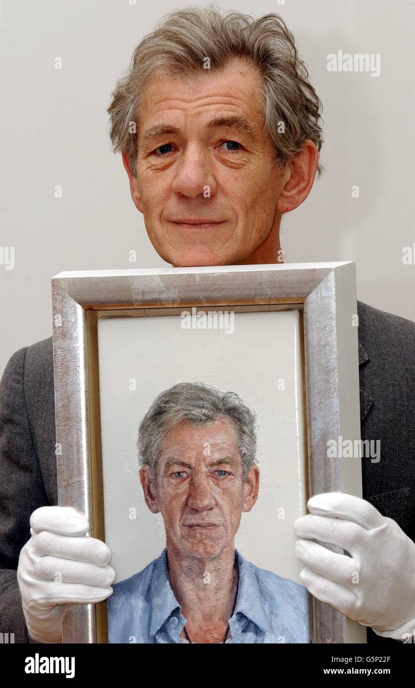 British actor Sir Ian McKellen with a new portrait of himself by Clive Smith during a photocall at the National Portrait Gallery in London. The work will go on public display from Wednesday 27 February 2002. The work has been commissioned by the National Portrait Gallery, * from the artist, who is a previous winner of the BP Portrait Award, as part of this prize. Stock Photo