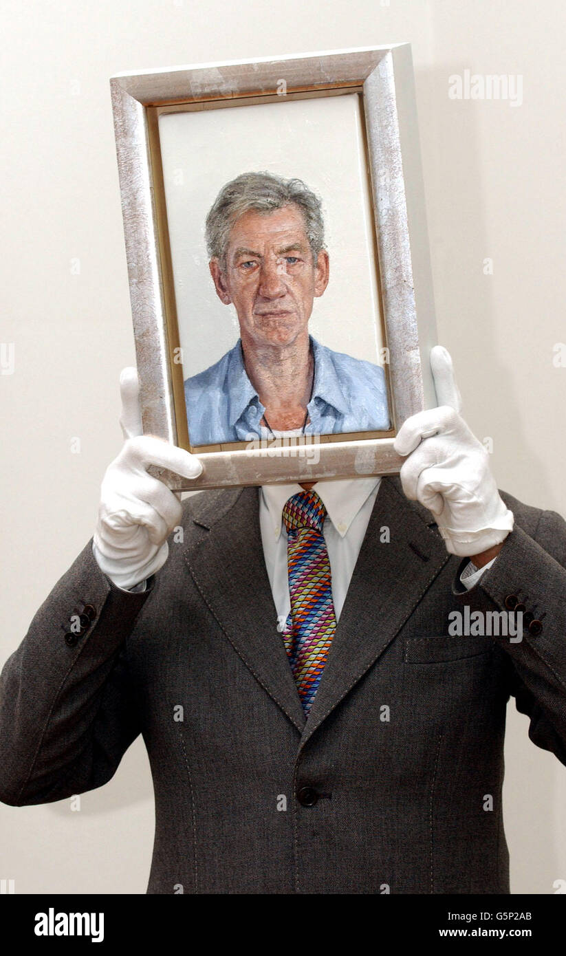 British actor Sir Ian McKellen with a new portrait of himself by Clive Smith during a photocall at the National Portrait Gallery in London. The work will go on public display from Wednesday 27 February 2002. * The work has been commissioned by the National Portrait Gallery, from the artist, who is a previous winner of the BP Portrait Award, as part of this prize. Stock Photo