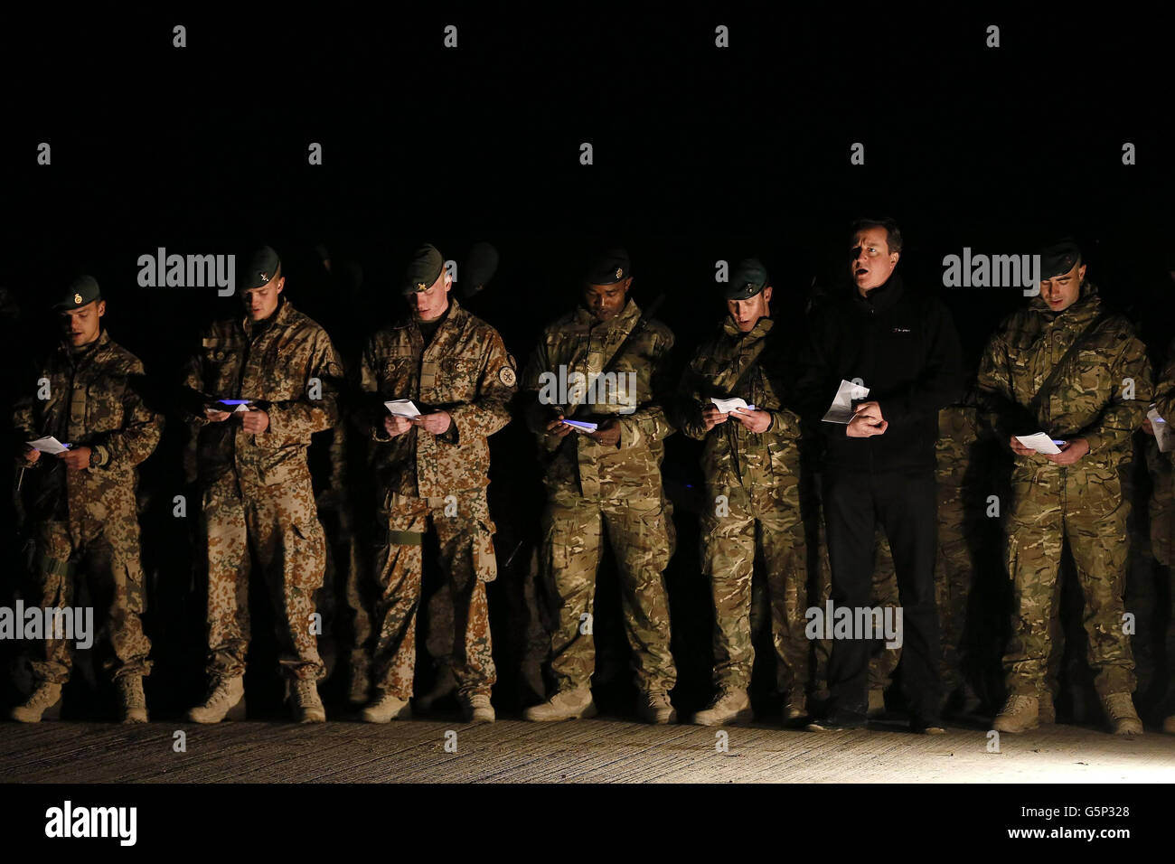 Prime Minister David Cameron attends a carol service with British soldiers, as well as Danish and Bosnian soldiers, during a visit to Forward Operating Base Price in Helmand Province, Afghanistan . Stock Photo