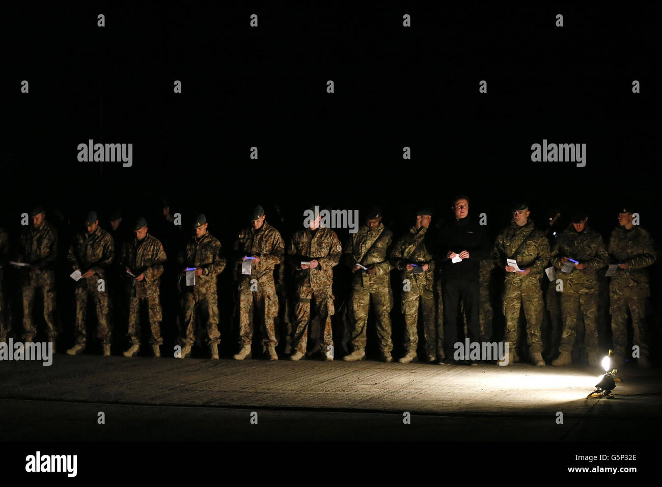 Prime Minister David Cameron attends a carol service with British soldiers, as well as Danish and Bosnian soldiers, during a visit to Forward Operating Base Price in Helmand Province, Afghanistan. Stock Photo