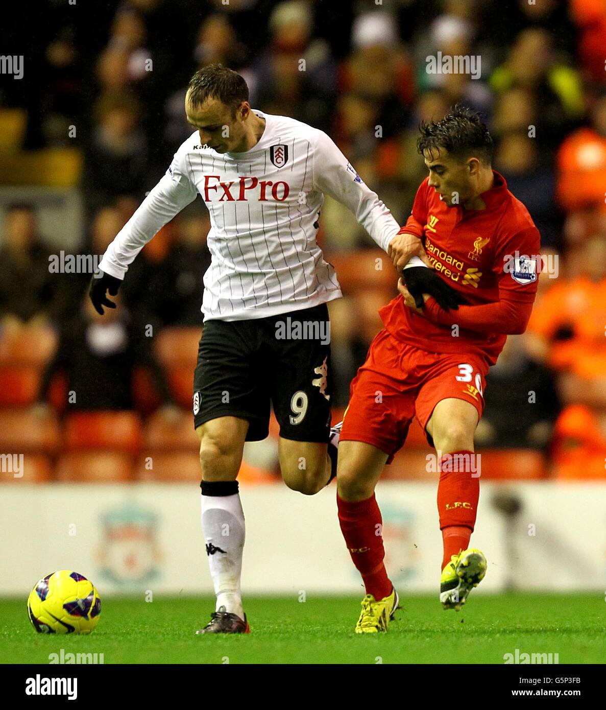 Fulham's Dimitar Berbatov (left) and Liverpool's Suso battle for the ball Stock Photo