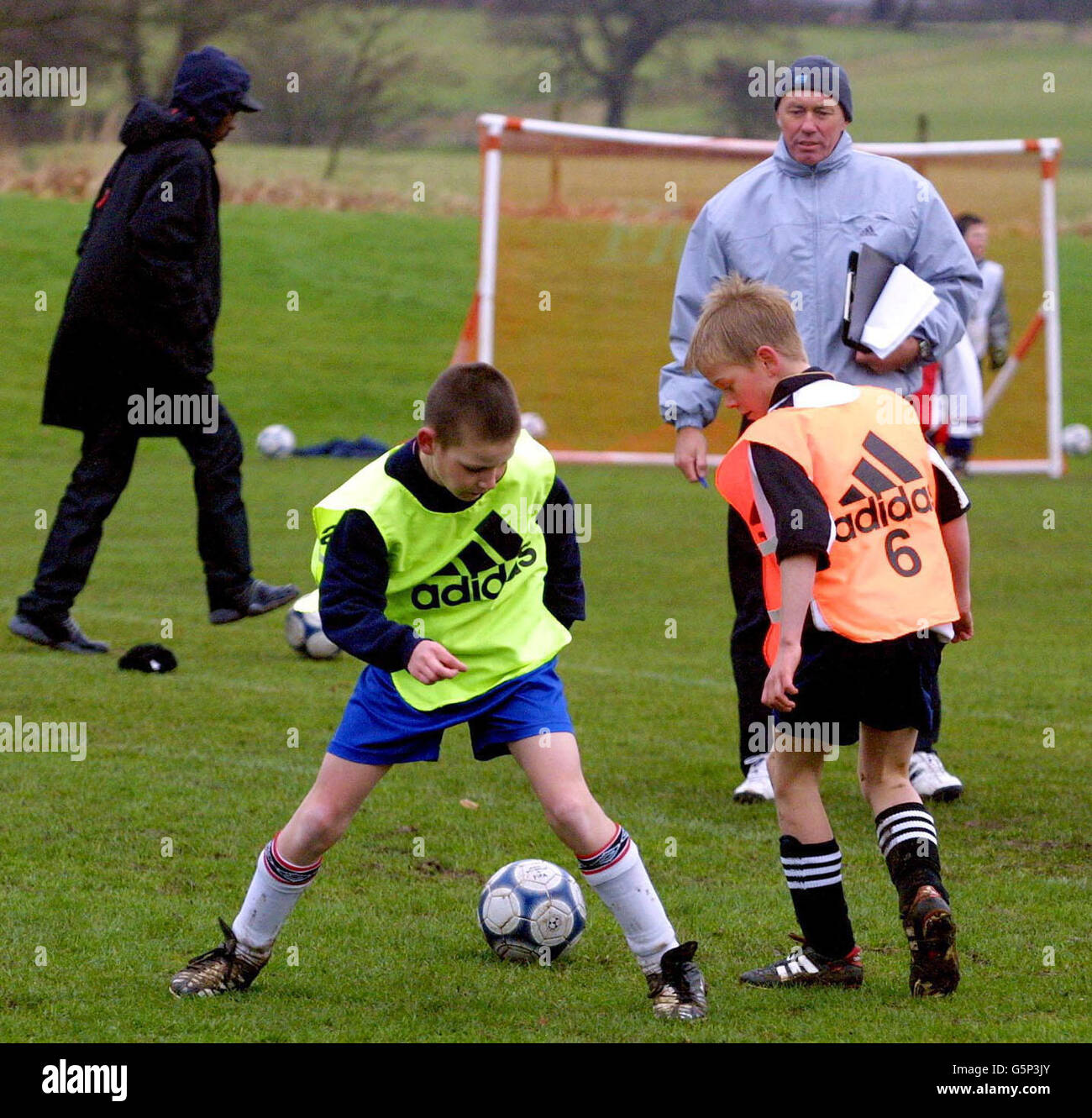 Northern Ireland manager Sammy McLlroy watches Elliott Miller, 11, (right) from Whetston, London, battle with Daniel Blackhall, 11, from West Bromwich during the Fox Kids Cup trials for Team UK, at Mottram Hall, Cheshire. * Fox Kids is embarking on a nationwide hunt for the football stars of tomorrow to play in a six-a-side tournament, the Fox Kids Cup in Barcelona. Stock Photo