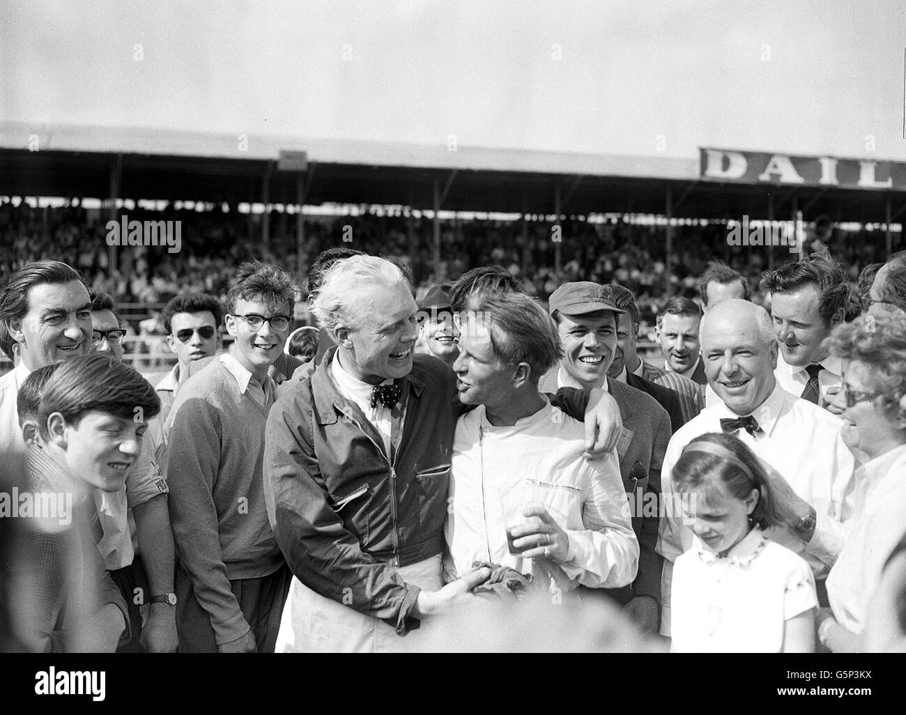 Peter Collins, winner of the British Grand Prix at Silverstone,is congratulated by runner up Mike Hawthorn. Collins, driving a Ferrari, won at an average speed of 102.05 miles an hour. Stock Photo