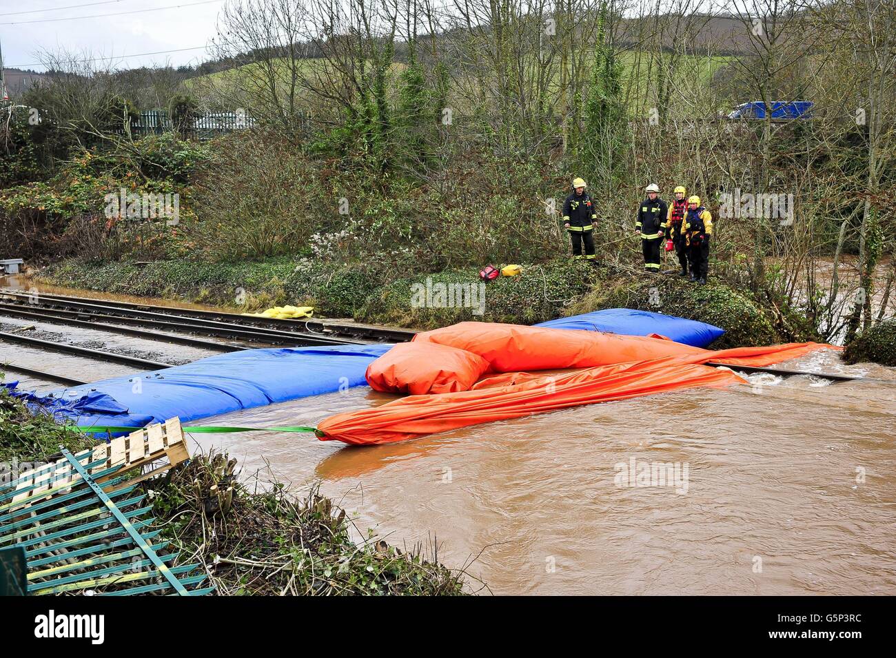 Railway engineers and Fire and Rescue service personnel watch over the
