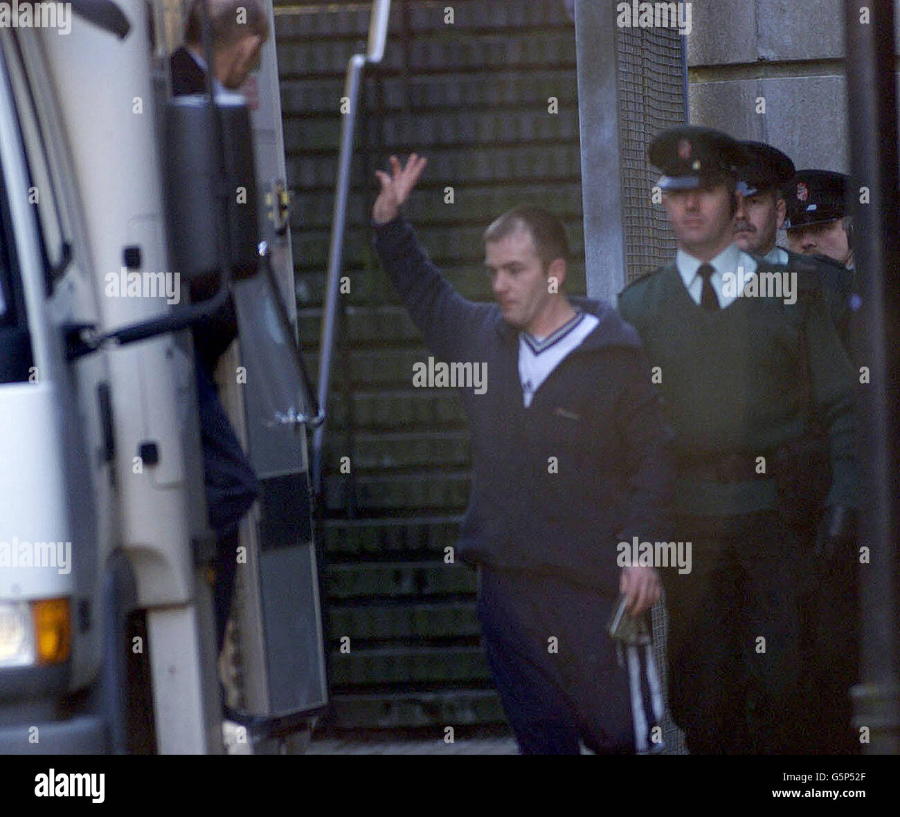 David (Eggy) Mooney is escorted to a prison van at Ballymena Court house. He was one of eighteen people arrested yesterday in a province-wide swoop by police targeting heroin users and dealers. He was remanded in police custody with four other men. Stock Photo