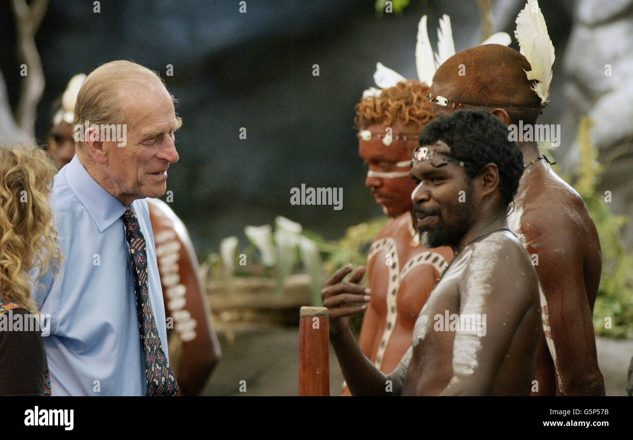 The Duke of Edinburgh talks to Aboriginal performers after watching a culture show at Tjapukai Aboriginal Culture Park, Cairns, Queensland, Australia. The Duke surprised the aborigines when he asked them 'Do you still throw spears at each other?' *The Royal couple watched a performance by the Tjapukai dance troop of nine Aboriginal male dancers in loin cloths and wearing body paint, and a didgeridoo player. Stock Photo