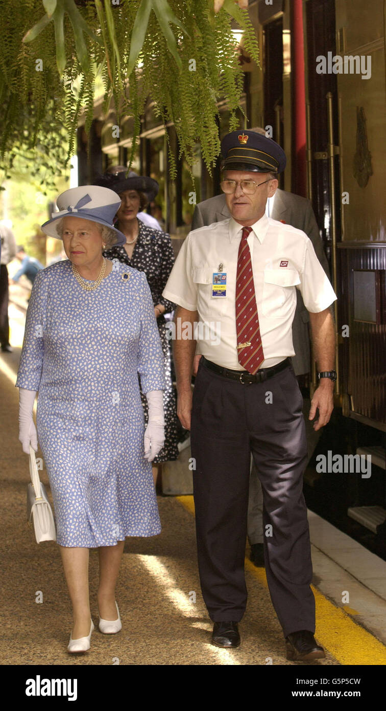 Britain's Queen Elizabeth II is et by Station Master Neville Smith as she arrives at Kuranda Railway Station, Queensland, Australia. Stock Photo