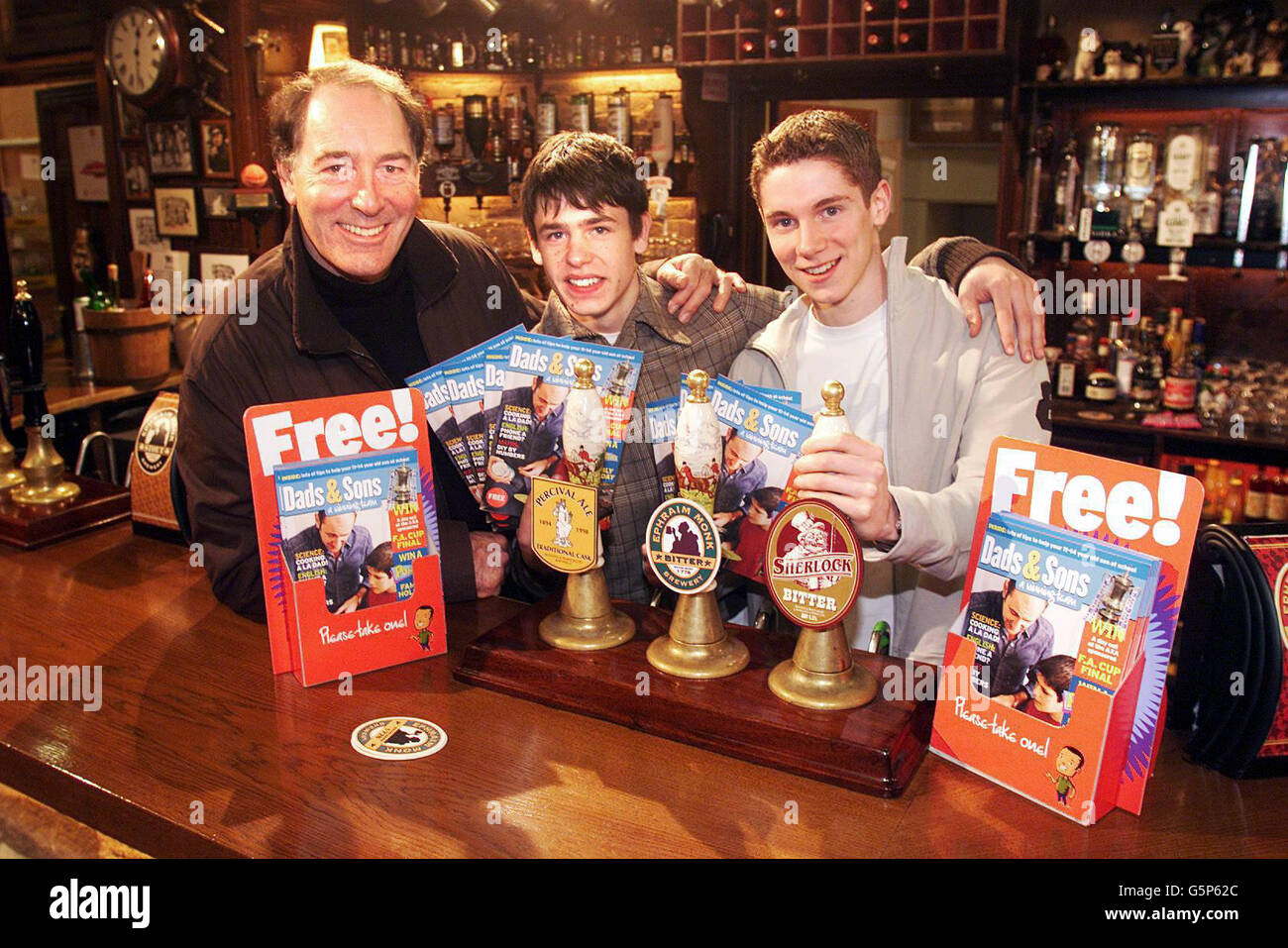 Emmerdale's Jack Sugden, played by Clive Hornby with his two on-screen sons Robert, played by Karl Davies (R) and Andy, played by Kelvin Fletcher at the Woolpack during the launch of the Dad's and Son's Campaign on the Emmerdale set in Leeds. * The Sugden family are backing the Department for Education and Skills' campaign to encourage dads to take an active role in their sons' education. Stock Photo