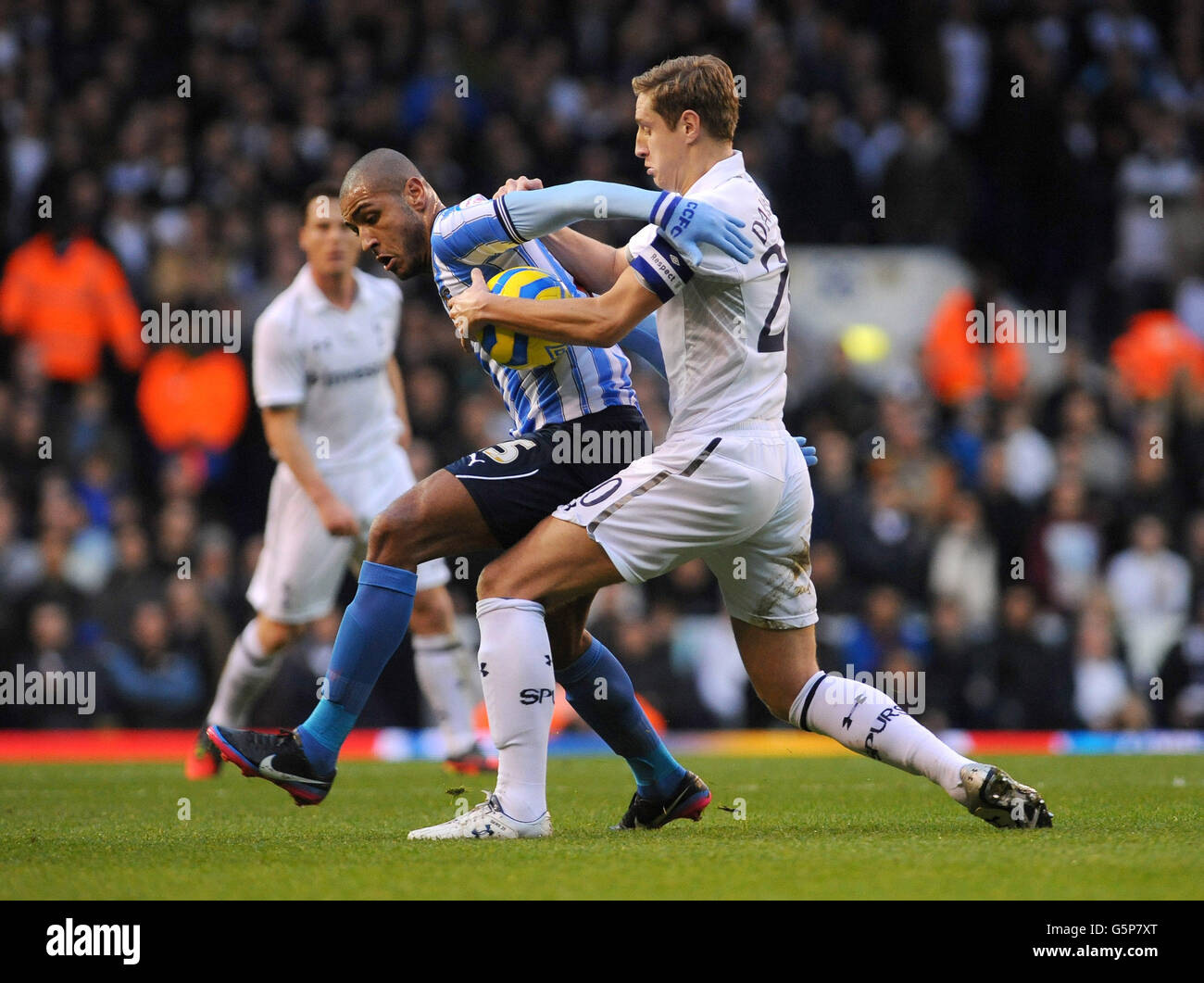 Coventry City's Leon Clarke (left) battles for the ball with Tottenham Hotspur's Michael Dawson during the FA Cup Third Round match at White Hart Lane, London. Stock Photo