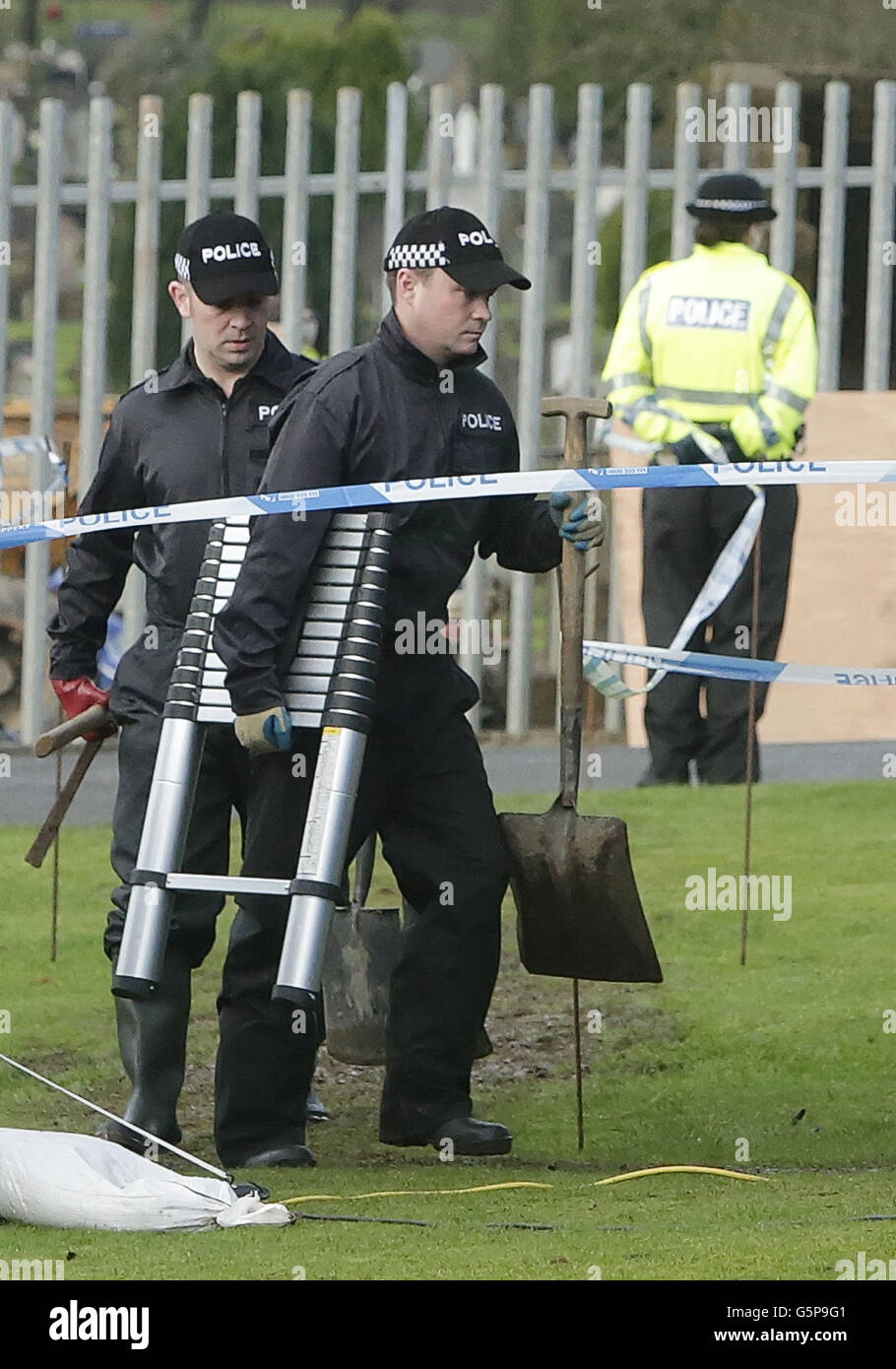 Police are pictured at Old Monkland Cemetery in Coatbridge in Scotland where an exhumation of the gravesite in the search for the remains of a schoolgirl Moira Anderson began today. Stock Photo