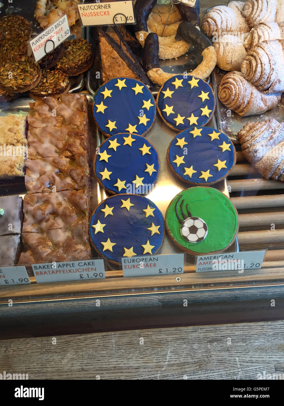 'Europeans, ' a variation of black and white cookie known as an 'American' in Germany, are can be seen in the display case at the German gourmet food shop 'Hansel & Pretzel' in the district of Richmond in London, Great Britain. The owners of the shop, Peter Wengerodt and Petra Braun, are using the cookie to alert their customers to the fact that they depend on the currency exchange between the euro and pound. The 'European' is 20 cents more than a normal 'American.' If the pound loses value in the case of a Brexit, then they will have to buy their products at a higher price in Germany and rais Stock Photo