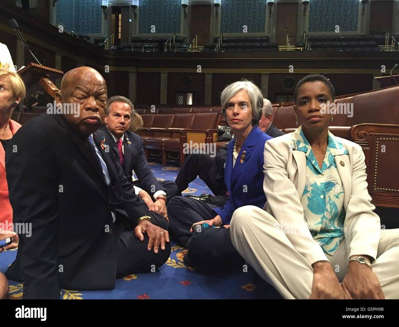 Washington DC., USA. 22nd June, 2016. U.S Rep. John Lewis, sitting left, leads a group of Democrats from the House and Senate to stage a sit in on the floor of the U.S House of Representatives demanding to vote on gun control legislation June 22, 2016 in Washington, DC. This is only the second time since 1970 that a party has staged a sit-in to demand a vote. Credit:  Planetpix/Alamy Live News Stock Photo