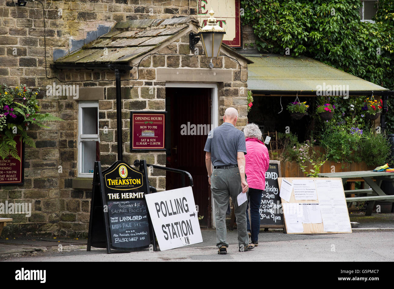 The Hermit, a village pub in Burley Woodhead, West Yorkshire, Britain. 23rd June, 2016. About to cast their vote, a couple arrive at this EU Referendum Polling Station. Credit:  Ian Lamond/Alamy Live News Stock Photo