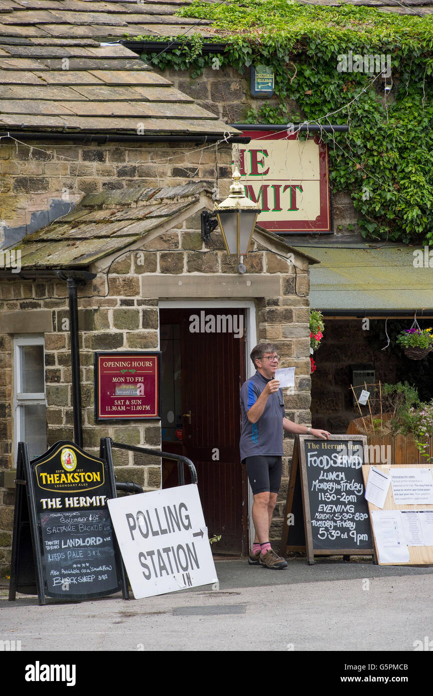 The Hermit, a village pub in Burley Woodhead, West Yorkshire, Britain. 23rd June, 2016. About to cast a vote, this voter marked the occasion of the EU Referendum by having his photo taken (posing with the election form) at the entrance to the Polling Station. Credit:  Ian Lamond/Alamy Live News Stock Photo
