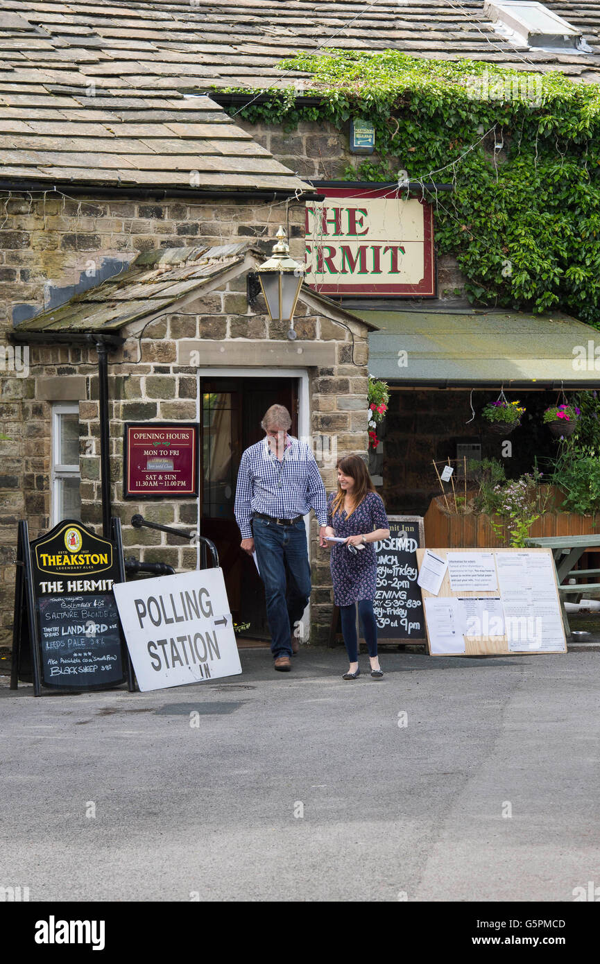 The Hermit, a village pub in Burley Woodhead, West Yorkshire, Britain. 23rd June, 2016. Having cast their vote, a couple of voters leave this EU Referendum Polling Station. Credit:  Ian Lamond/Alamy Live News Stock Photo