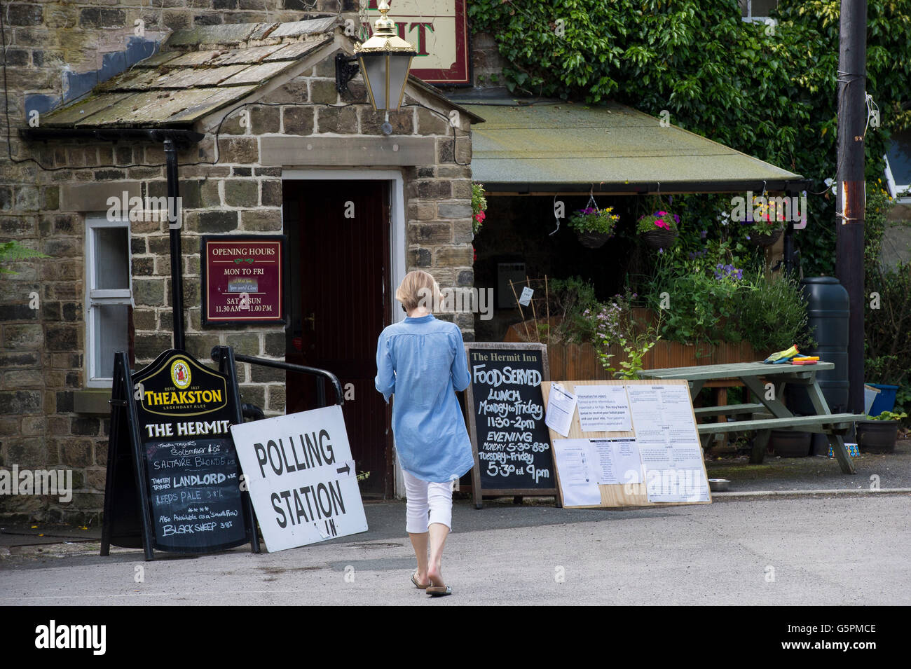 The Hermit, a village pub in Burley Woodhead, West Yorkshire, Britain. 23rd June, 2016. About to cast her vote, a lady arrives at this EU Referendum Polling Station. Credit:  Ian Lamond/Alamy Live News Stock Photo