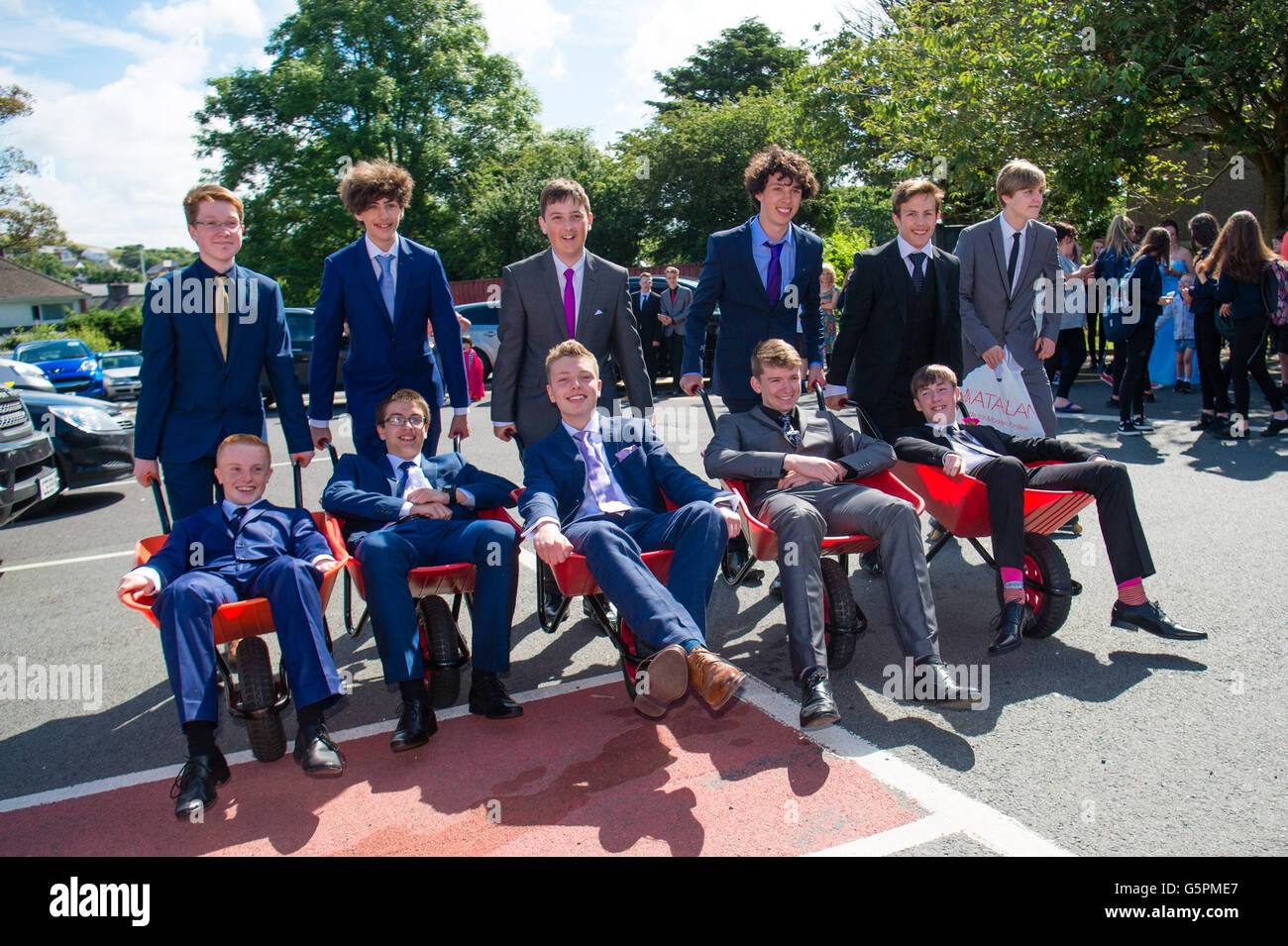 Aberystwyth, Wales, UK. 23rd June, 2016. . Year 11 students at Aberystwyth's Penglais secondary school wearing formal suits arriving in wheelbarrows to  celebrate their 'leavers day' in warm sunshine photo Credit:  keith morris/Alamy Live News Stock Photo