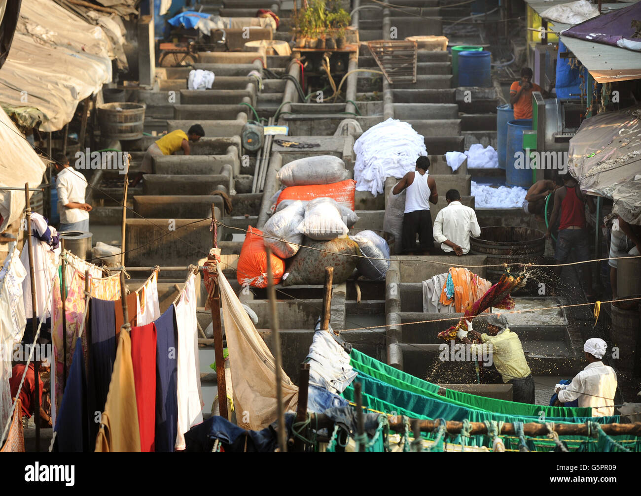 Washers, known locally as Dhobis, work in the open to wash clothes from Mumbai's households