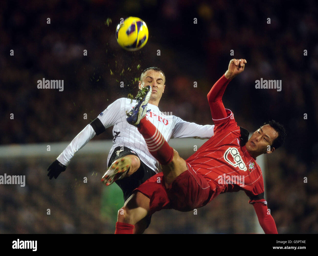 Fulham's Dimitar Berbatov and Southampton's Yoshida Maya battle for the ball during the Barclays Premier League match at Craven Cottage, London. Stock Photo