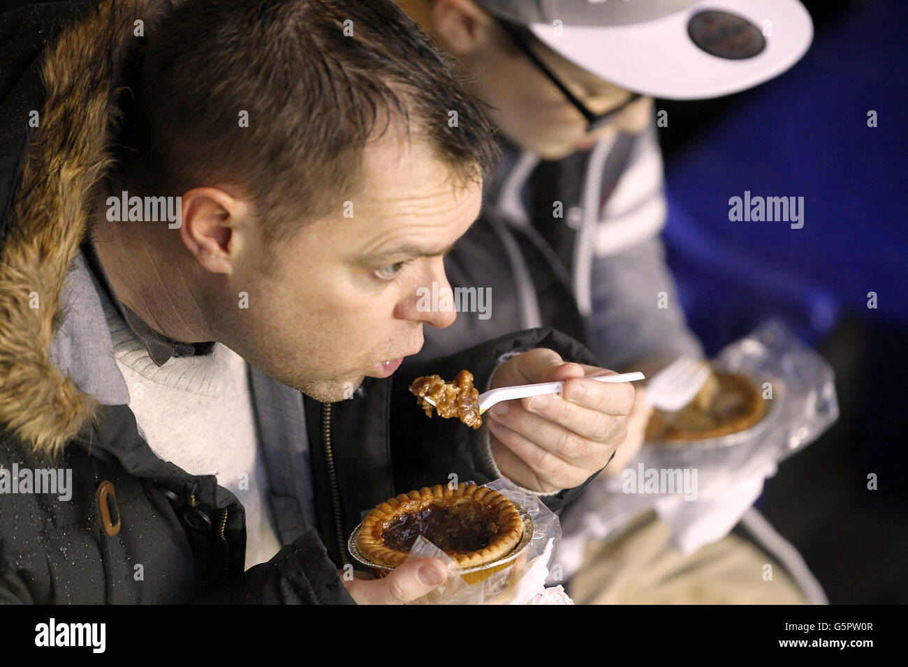 Soccer - Barclays Premier League - Everton v Wigan Athletic - Goodison Park. Fans tuck into a pre-match pie in the stands Stock Photo