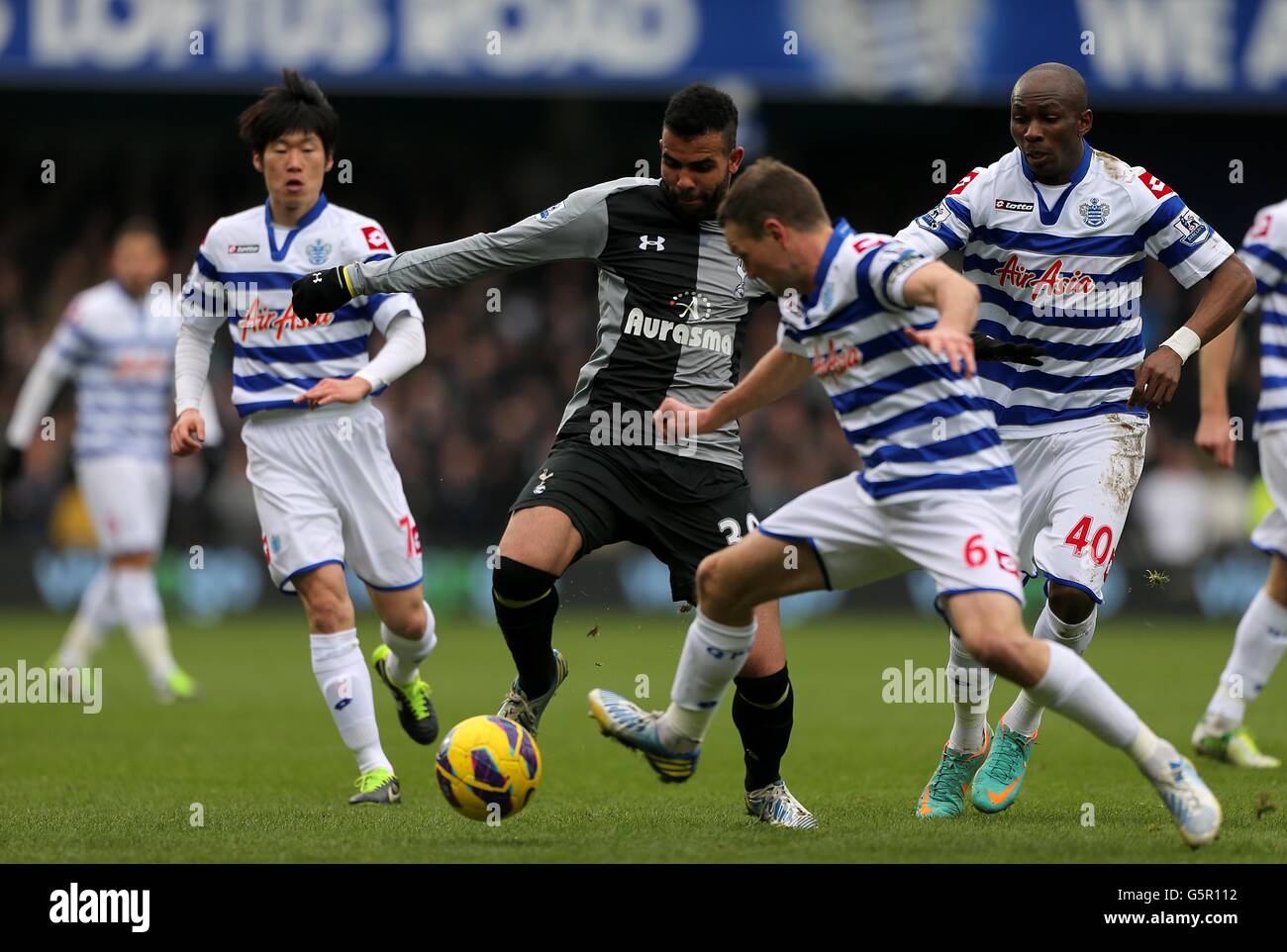 Tottenham Hotspur's Raniere Sandro (centre) is surrounded by Queens Park Rangers' Clint Hill (6), Stephane Mbia (right) and Ji-Sung Park (left) Stock Photo