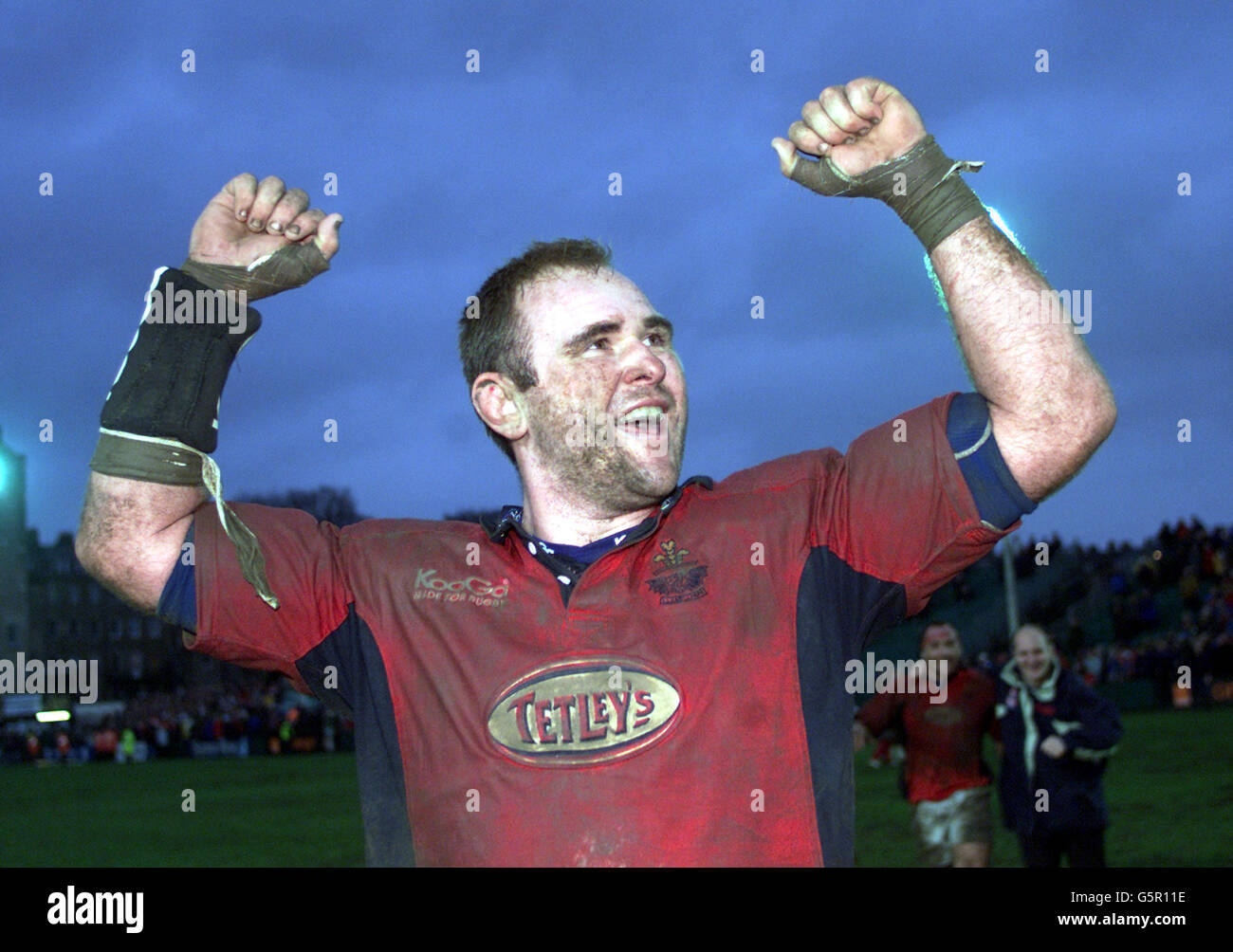 Llanelli captain Scott Quinnell celebrates victory after the Heineken