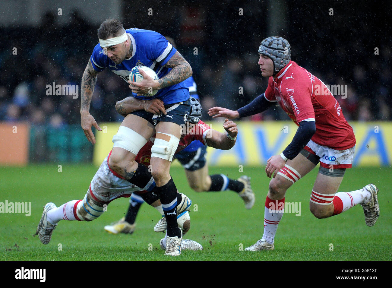 Bath's Ryan Caldwell is tackled by Agen's Uelenitoni Fono during the Amlin Challenge Cup Pool Four match at the Recreation Ground, Bath. Stock Photo