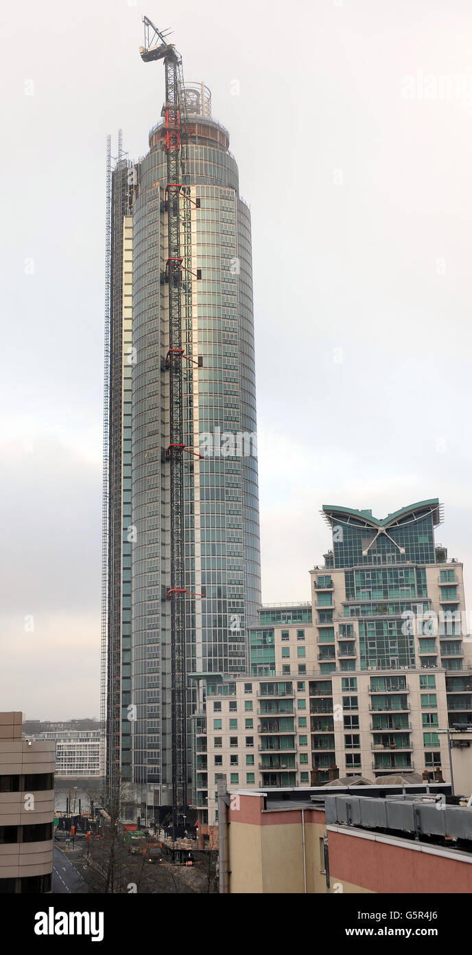 The mist shrouded crane at the top of St George's Wharf tower building, where a helicopter crashed into this morning, in Vauxhall south London. Stock Photo