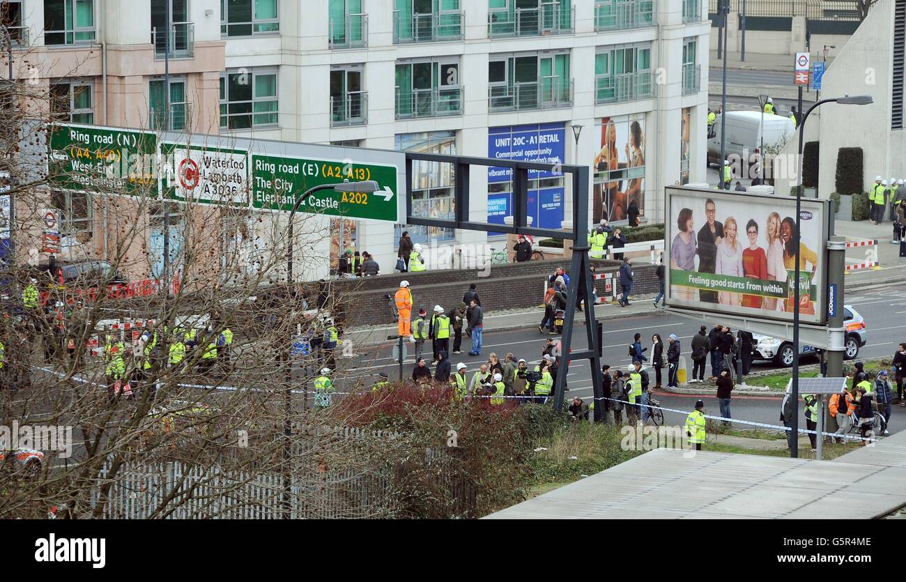 Police close off the Vauxhall Cross intersection, after a Helicopter crashed into a construction Crane on top of St George's Wharf tower building, in Vauxhall south London. Stock Photo