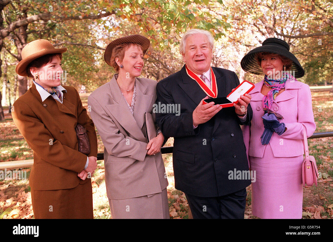 Sir Peter Ustinov, who was knighted at Buckingham Palace is shown with his wife, Lady Helene (right) and daughters Tamara (left) and Andrea (far left). 29/03/2004: veteran British actor Sir Peter Ustinov, who died in Switzerland last night aged 82, it was announced, Monday March 29, 2004. Stock Photo