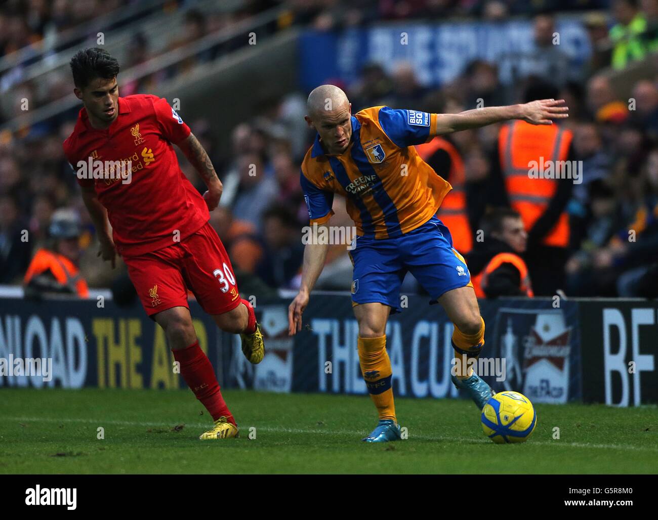 Liverpool's Jesus Fernandez Saez (Suso) (left) and Mansfield Town's Lindon Meikle battle for the ball Stock Photo