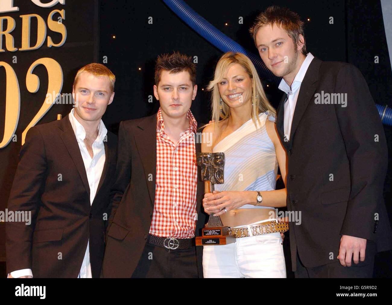 CD-UK presenters Brian Dowling (2nd left), Tess Daly and James Redmond  (right) receive their music and arts programme of the year award from  singer Ronan Keating. *.... during the 2002 TRIC (Television