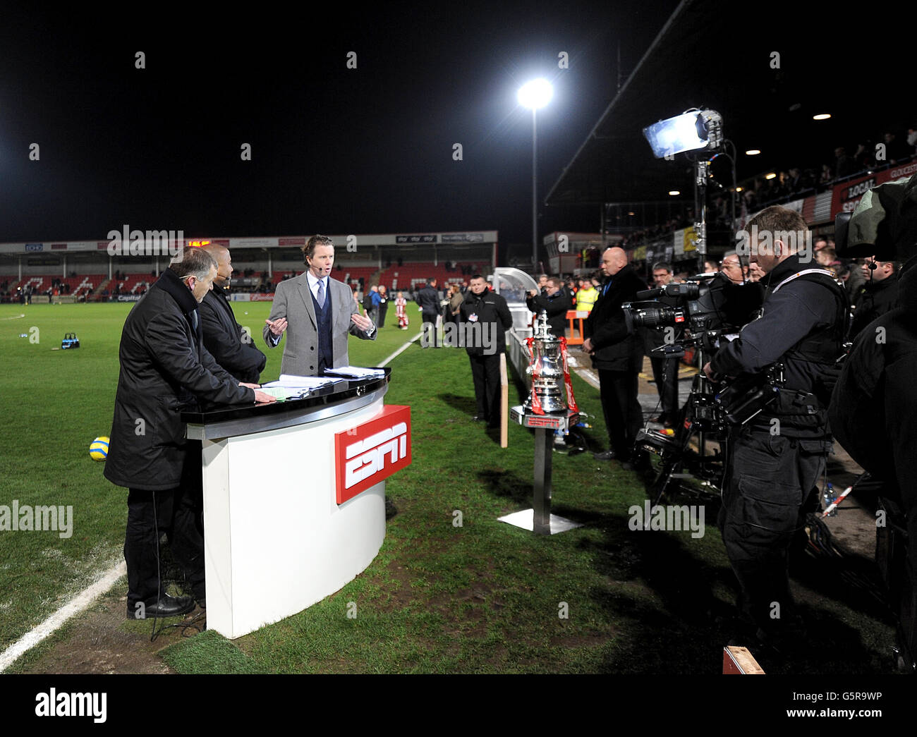 Camera crew film the ESPN tv presenters at the side of the pitch Stock