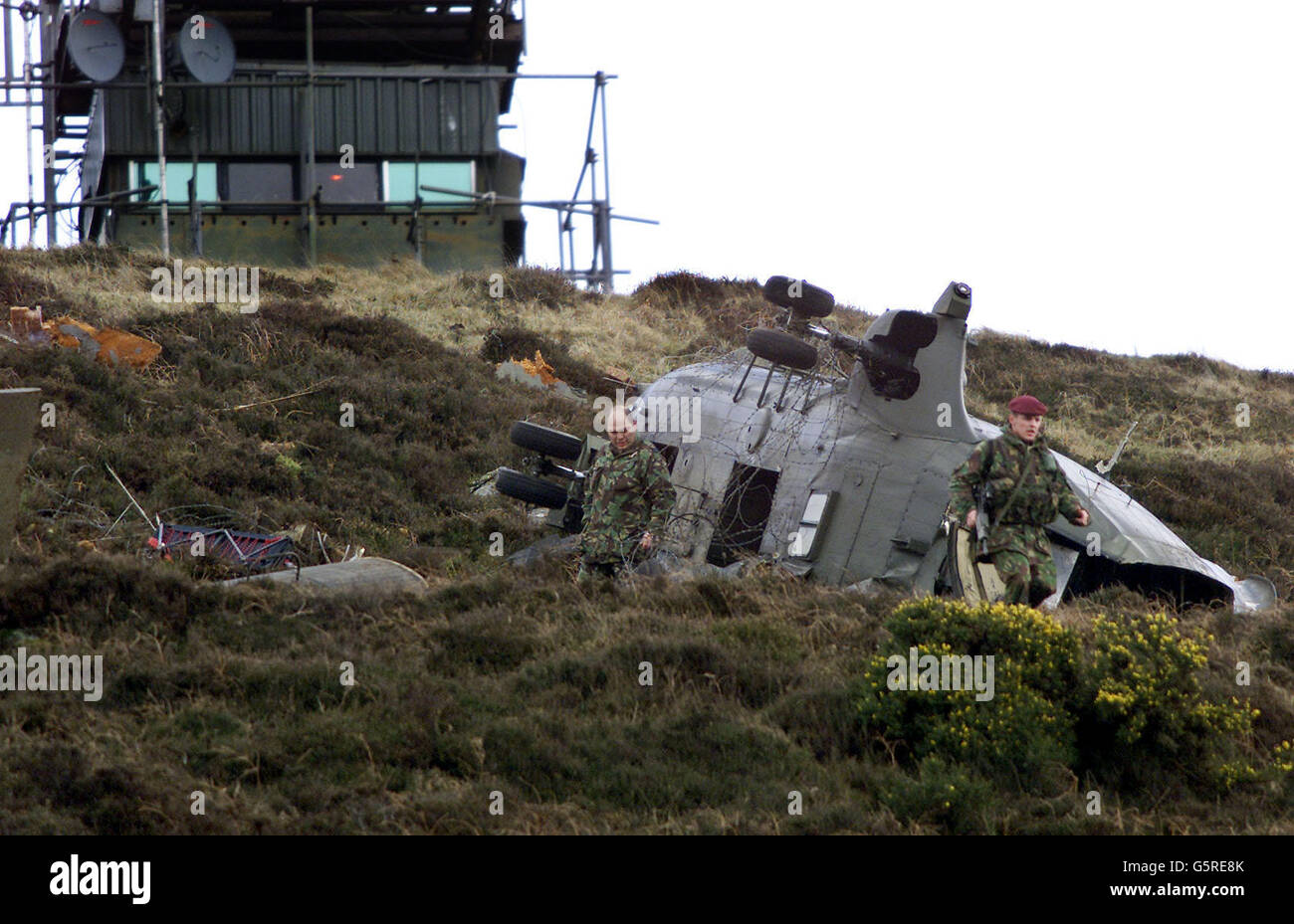 Soldiers examine the remains of the Puma Helicopter which crashed beside  Jonesborough watch tower in south Armagh. Eight people were airlifted to  hospital after the RAF helicopter crashed close to the Irish