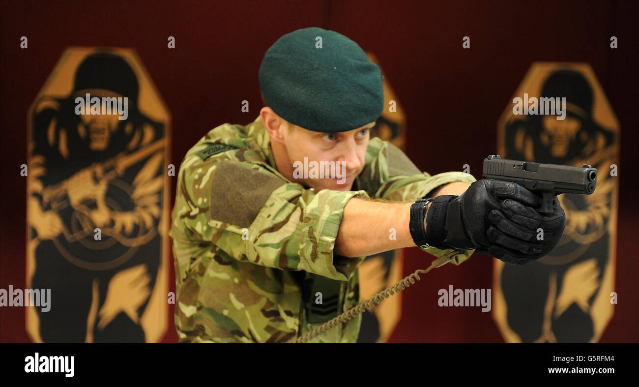 Royal Marine Sergeant Steve Lord tests a Glock 17 9mm pistol, on an indoor shooting range at Woolwich Barracks, south-east London, as personnel from all three services are to start using the new Glock pistols after a contract was awarded to replace the currently used Browning model. Stock Photo