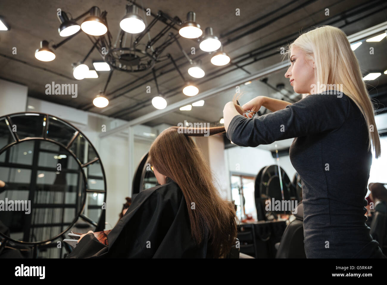 beautiful-female-hairdresser-doing-hairstyle-to-her-client-at-hair-salon-stock-photo-alamy