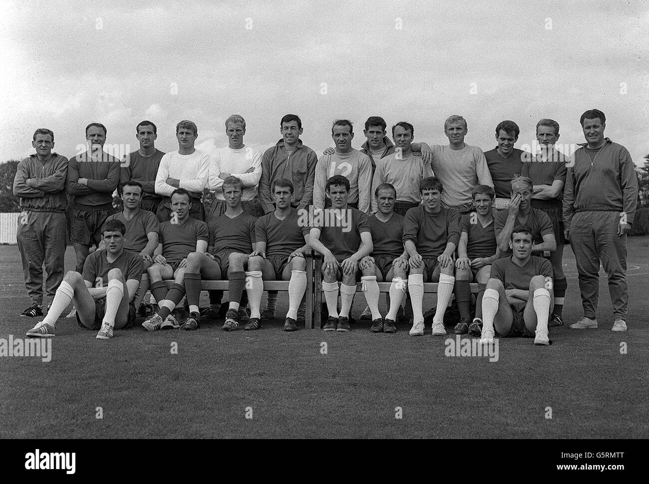 The 22 players and their trainers of the World Cup football team - Back Row Assistant trainer, Cocker, G. Cohen, G. Byrne, R. hunt, R. Flowers, G. banks, R. Springett, P. Bonetti, J. Greaves, B. Moore, J. Connelly, G. Eastham and H. Shepherdson trainer. Seated - J. Armfield, N. Stiles, G. Hurst, T. Paine, R. Wilson, M. Peters, A. Ball, and R. Charlton. Foreground - N. Hunter and I. Callaghan. Stock Photo