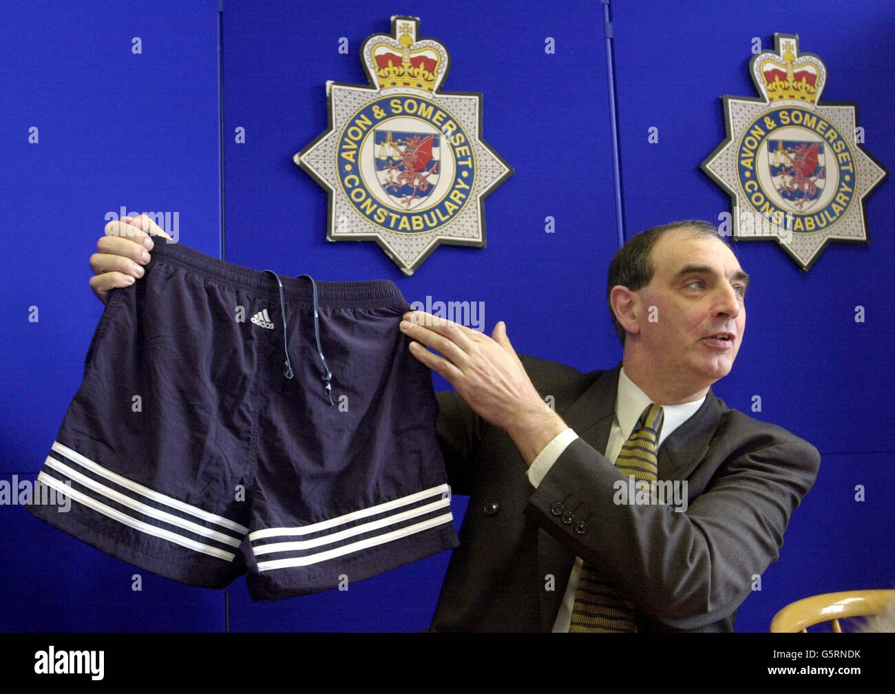 Detective Chief Inspector Barrie Douglas, who is leading the enquiry into the death of a man found on Exmoor, Somerset, holds a similar pair of shorts to those found on the dead man during a press conference at Taunton Police Station. * Police are trying to identify the man in his 20s, whose badly decomposed body was found in a black plastic bag on remote moorland in the national park at the end of February. Stock Photo