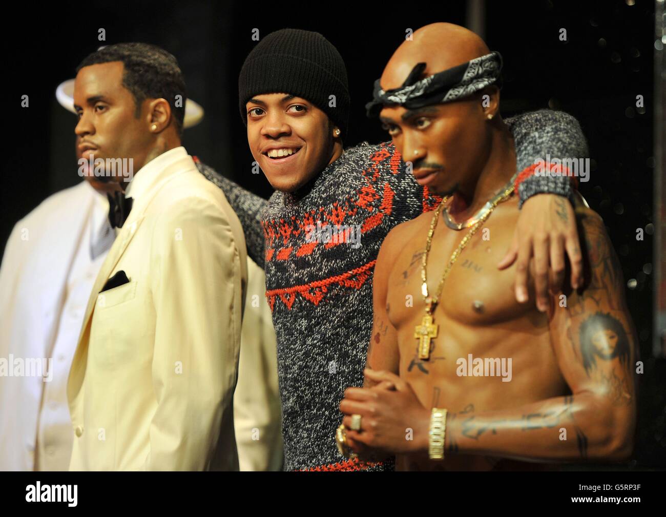 UK rap star 'Chip' (centre), gets a close up look at two of the four US ...