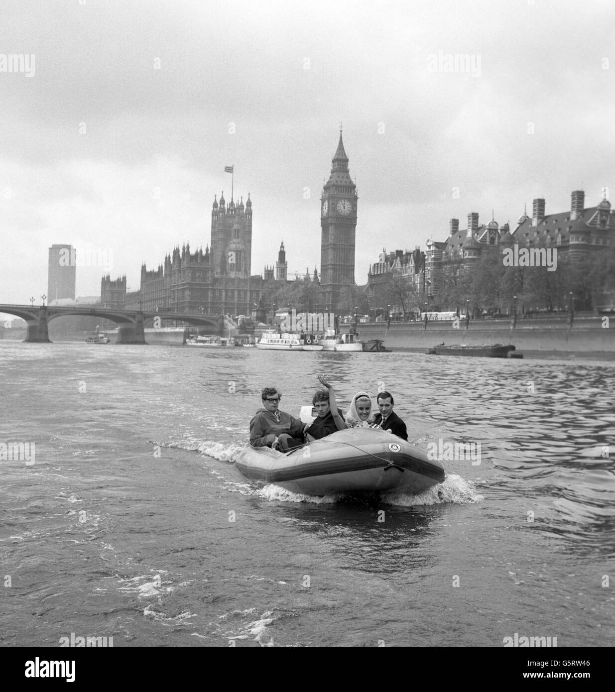 Scotsman Dougal Haston, conqueror of the Eiger (second from left) has Lesley Langley (Miss World) and Labour MP Mr Michael English (Nottingham W.) - on right - as companions on the trip by inflatable speedboat from Westminster to Charing Cross where Lasley opened the National Camping Week exhibition. Paul Ailey drives the boat, which has a top speed of over 50 knots. The exhibition is the prelude to Nationsl Camping Week. Lesley is a former Miss Camping. Stock Photo