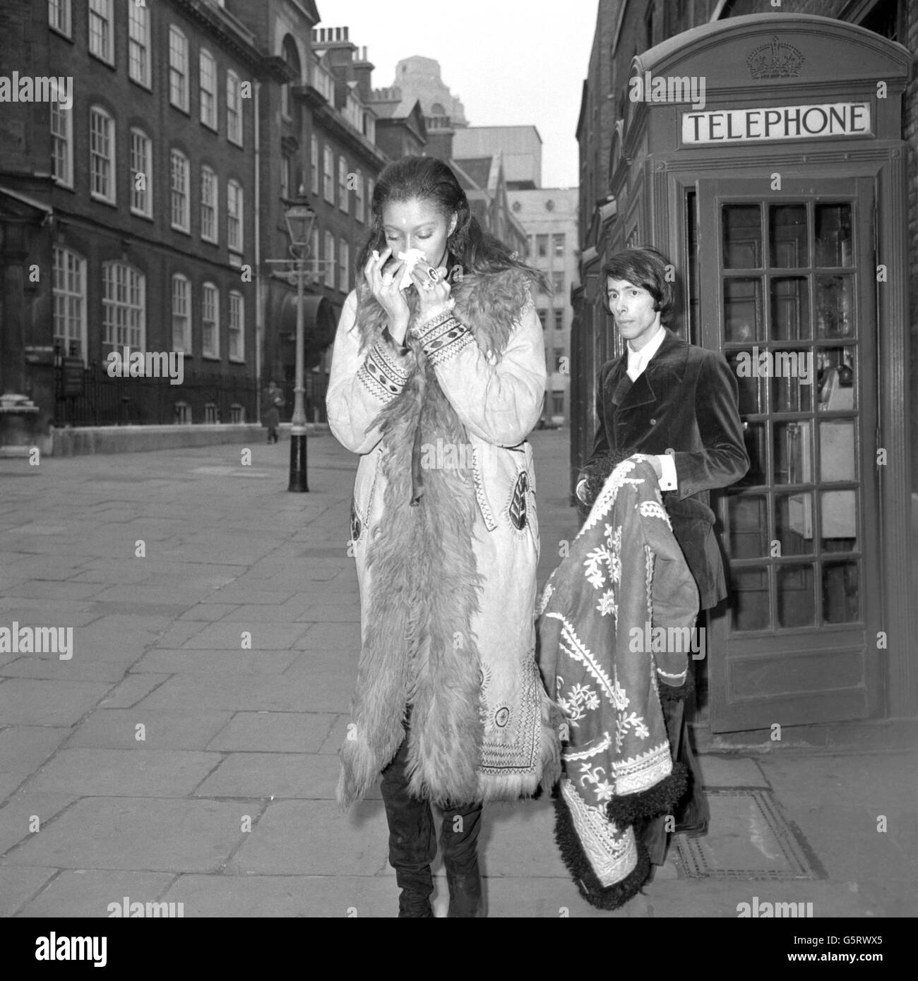 American model Donyale Luna blows her nose on a tissue while in London with American journalist Steve Brandt. Their Canadian-born actor-producer friend Iain Quarrier (not pictured) is due to appear at Bow Street (London) Court after being charged for obstructing the police. Stock Photo