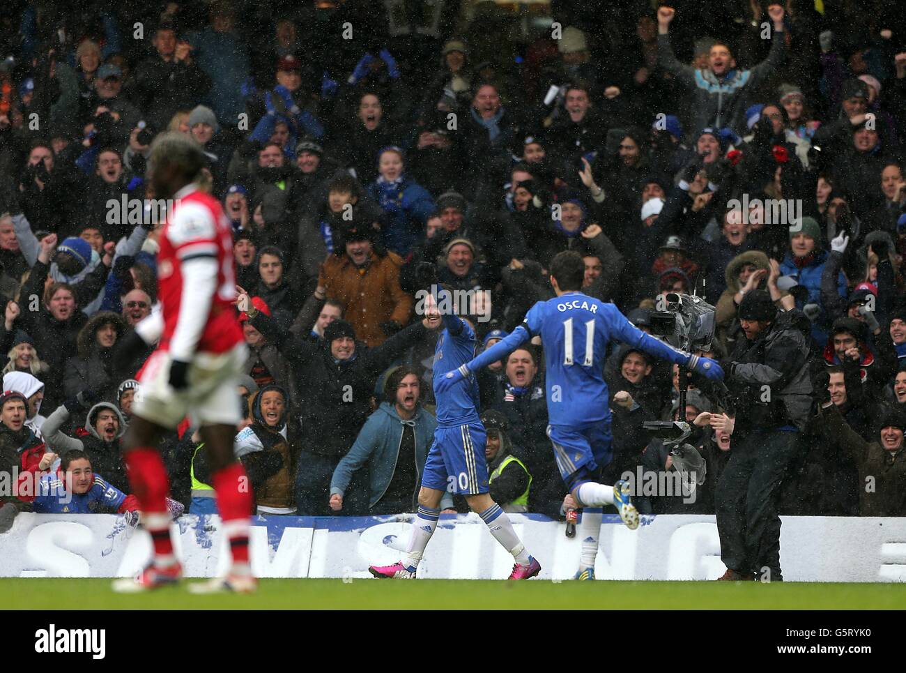Chelsea's Juan Mata (centre) celebrates scoring his side's first goal of the game in front of the fans Stock Photo