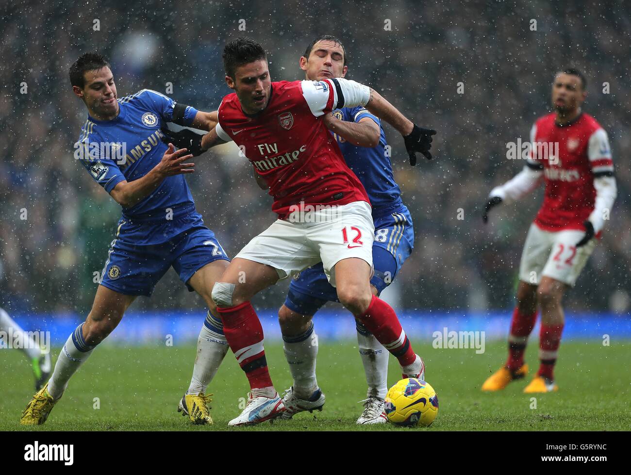 Arsenals' Olivier Giroud attempts to hold off Chelsea's Frank Lampard (right) and Cesar Azpilicueta (left) Stock Photo