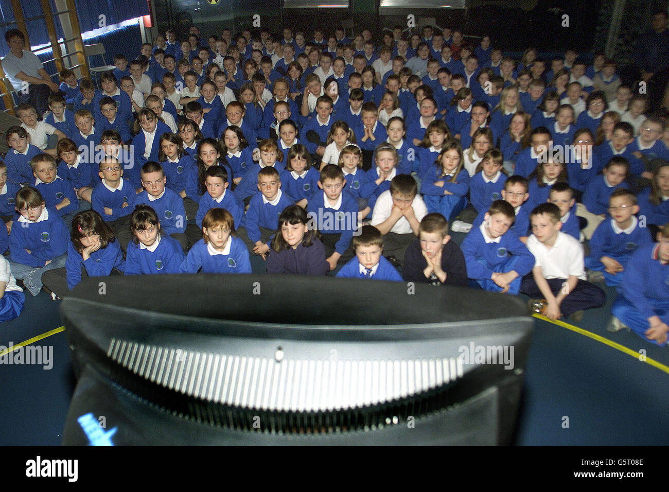 Children from Broughshane Primary school in Northern Ireland watch the Queen Mother's funeral on television. Stock Photo