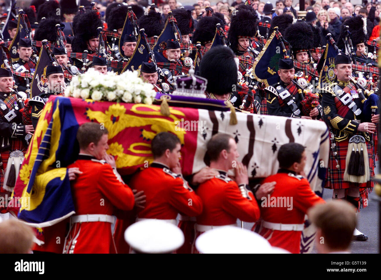 Pallbearers carry the coffin of the Queen Mother past massed Army