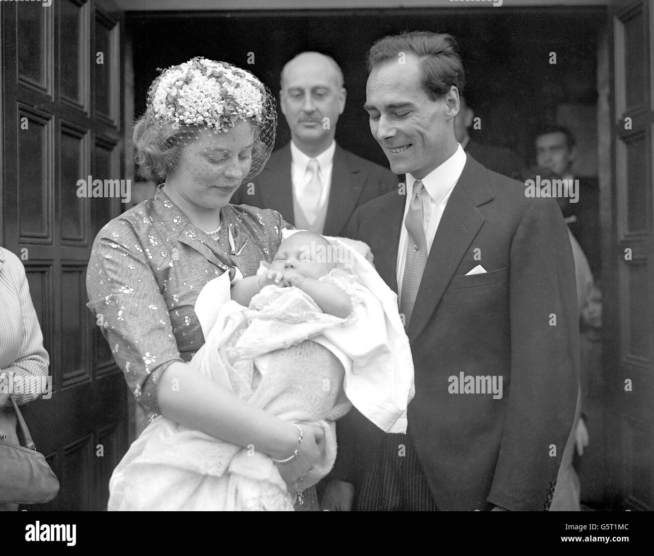 Prince and Princess Tomislav of Yugoslavia with their son, Nikola, after the baby had been christened at the Serbian Church in Ladbroke Grove, London. In the centre is the Margrave of Baden, the baby's grandfather, who was godfather to Nikola. Before her marriage, Princess Tomislav was Princess Margarita of Baden and is the niece of the Duke of Edinburgh. Prince Tomislav is the brother of ex-King Peter of Yugoslavia. Stock Photo