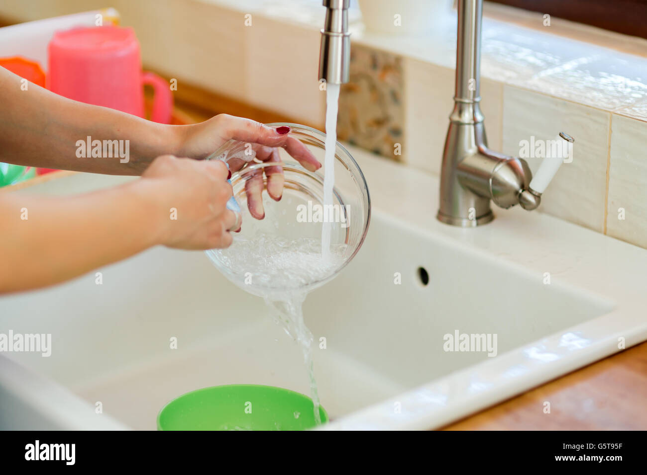 Woman washing dishes by hand Stock Photo Alamy